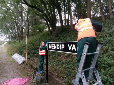 the completed sign being erected by Toby and Anwen
